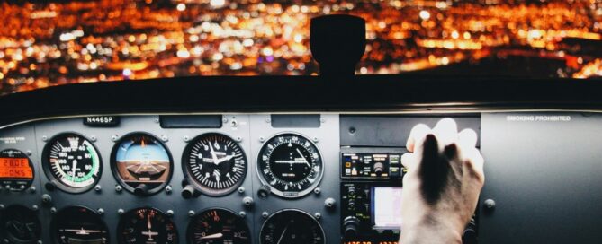 a hand on the control panel of a plane