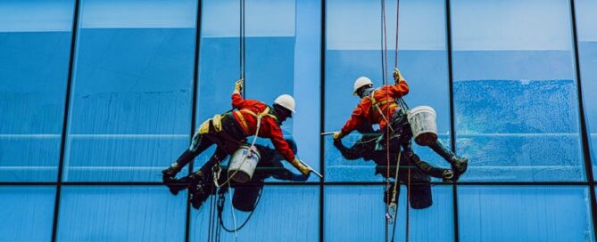a group of men cleaning a building