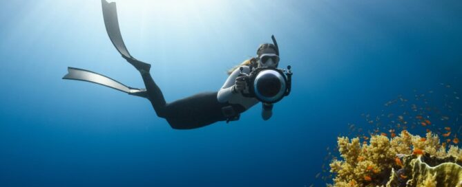 a woman underwater with a camera