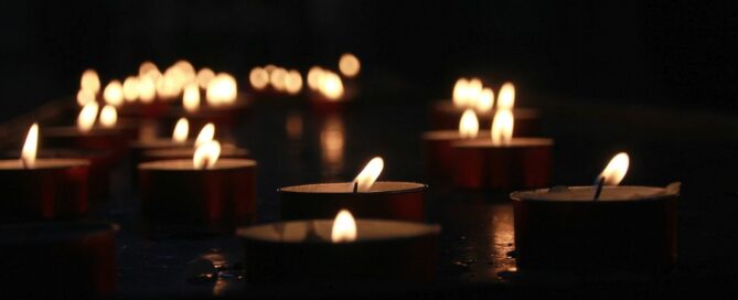 a group of candles lit up in the dark