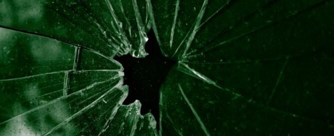 a broken glass with a hole in it