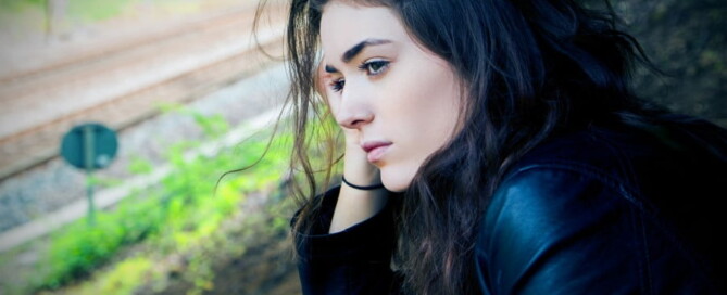 a woman sitting on a train track