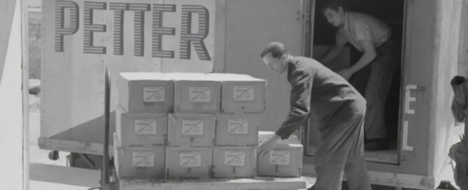 a man pushing a cart full of boxes
