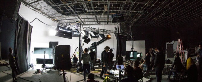 a group of people in a room with equipment and lights