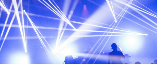 a crowd of people on a stage with bright lights