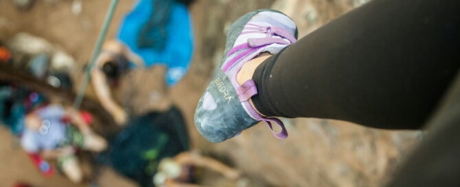 a person's foot on a rock wall