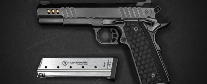 a gun and magazine on a black surface