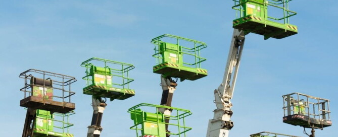 a group of green scissor lift platforms